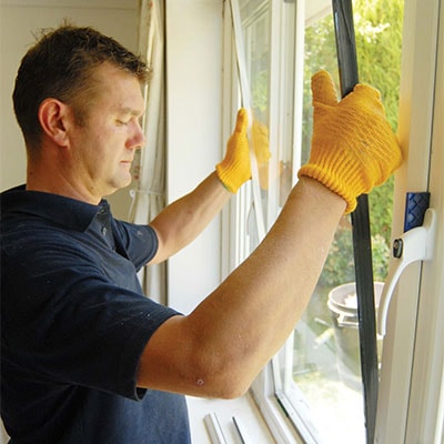 Anglian fitter installing a window