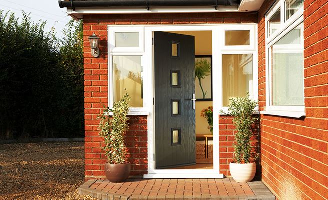 Black composite front door with step in contemporary style with double glazed side windows from Anglian Home Improvements