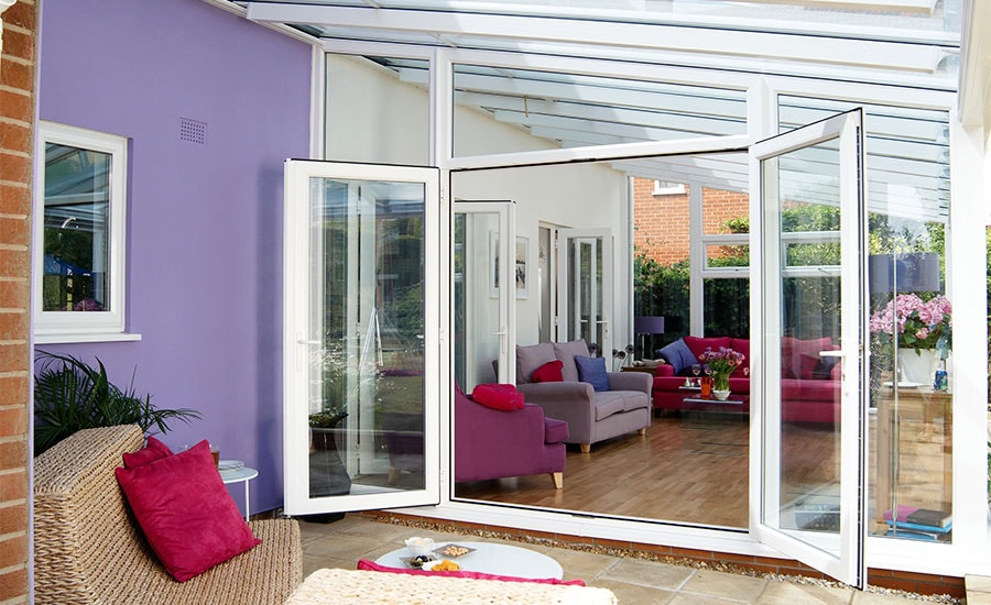 White UPVC contemporary gable end Veranda conservatory with French doors opening onto veranda space from Anglian Home Improvements