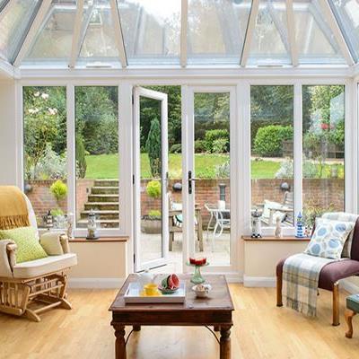 White UPVC Elizabethan conservatory with glass roof and large French doors interior living space view from the Anglian conservatories range