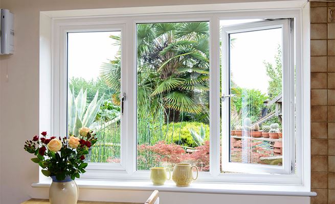 Double glazed UPVC casement window finished in White with chrome handles from Anglian Home Improvements