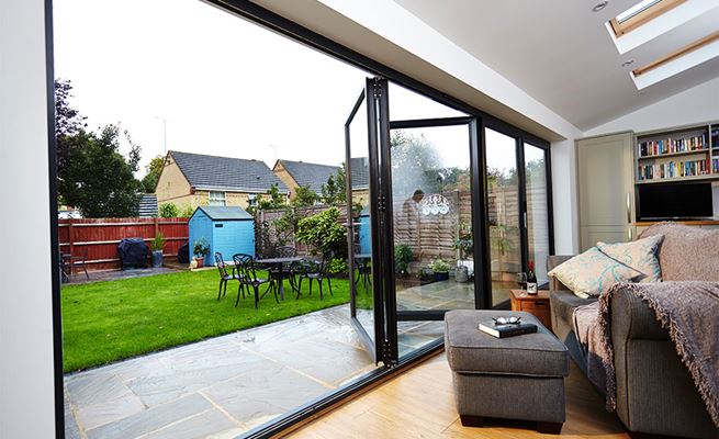 Five panel Jet Black aluminium bi-fold doors on a rear house extension from the Anglian bi-fold doors range