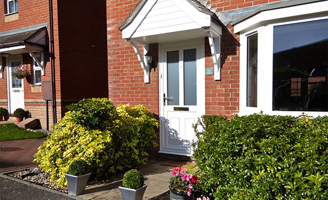 White uPVC Victorian style front door on a contemporary house from the Anglian uPVC front door range