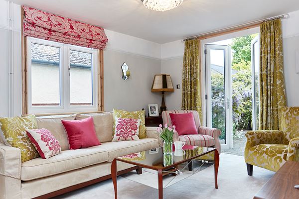 Interior view of living room finished with Dual White and Cream UPVC casement window and French doors