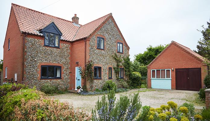 Anthracite Grey UPVC double glazed casement windows and composite front door finished in Duck Egg Blue from Anglian Home Improvements