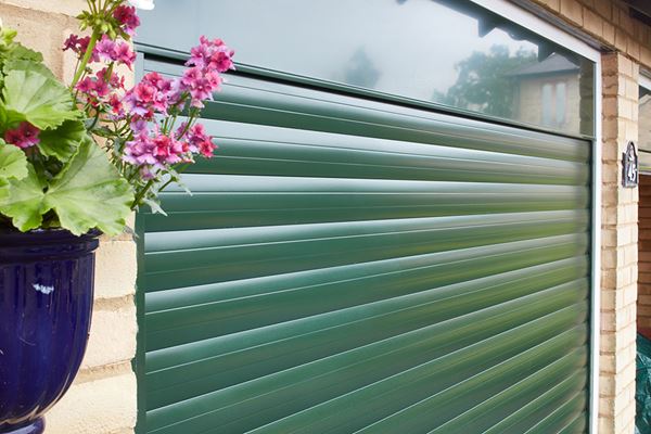 Side view of electric roller garage door in Fir Green from the Anglian garage door range