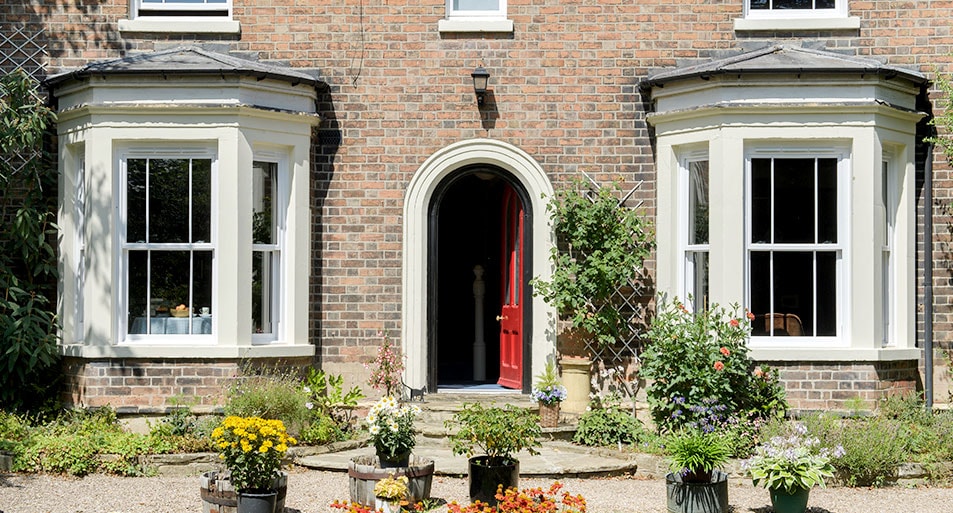 Two Three Panel Bay Windows with White uPVC Sash Windows with Glazing Bars in a Tramline Design