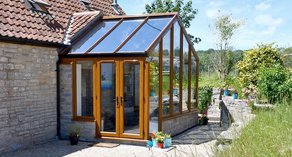 Golden oak conservatory with French doors