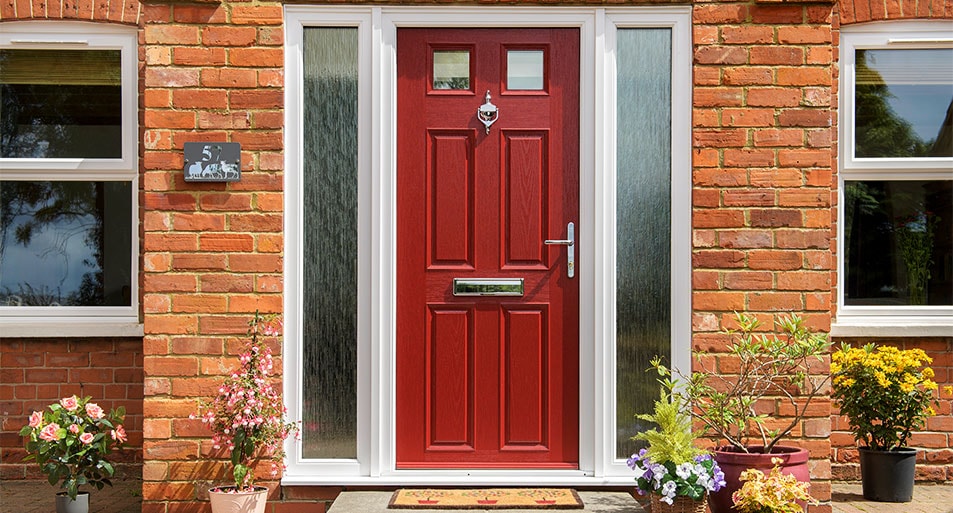 Red Composite Front Door With Two Small Glazed Top Panels in a Six Panel Design with a Chrome Knocker and Handles