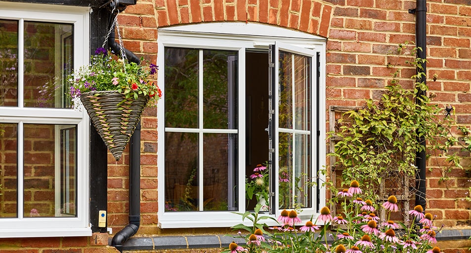 white casement window with Georgian bar inserts in open position