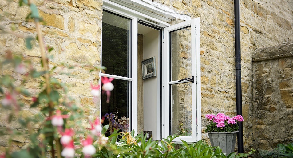 White Timber Casement Window with Black Handles and Central Horizonal Astragal Bars Open on One Side