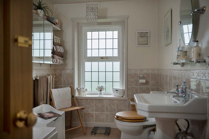 Wooden casement window in white with frosted glass and lead bars from the Anglian windows range