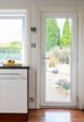 White kitchen uPVC back door with clear fully glazed panel chrome handle and hinges interior view from the Anglian back door range