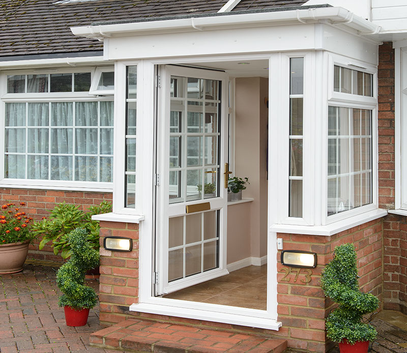 White uPVC porch and windows with Georgian bars with open front door