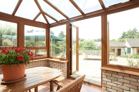 Golden oak uPVC Edwardian conservatory with French doors