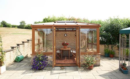 Golden Oak conservatory with french doors and garden view