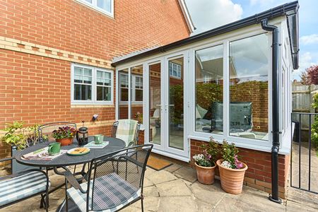 White uPVC Edwardian conservatory with French doors in closed position