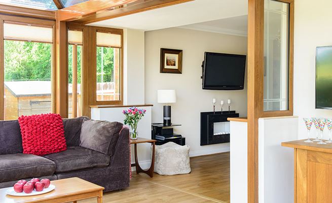 Golden Oak UPVC Edwardian conservatory interior view opening onto living room space from the Anglian classic conservatory range