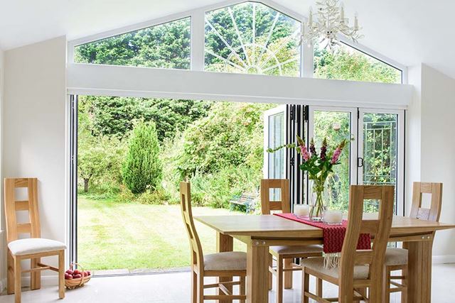 Solid roof extension with white bifold doors