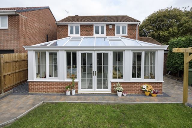 Classic white Orangery with white uPVC French doors and windows with Georgian bars