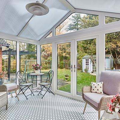 White uPVC Rengency conservatory with French doors and Polycarbonate roof interior
