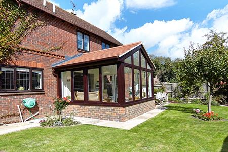 Traditional tile extension with uPVC dark woodgrain French doors