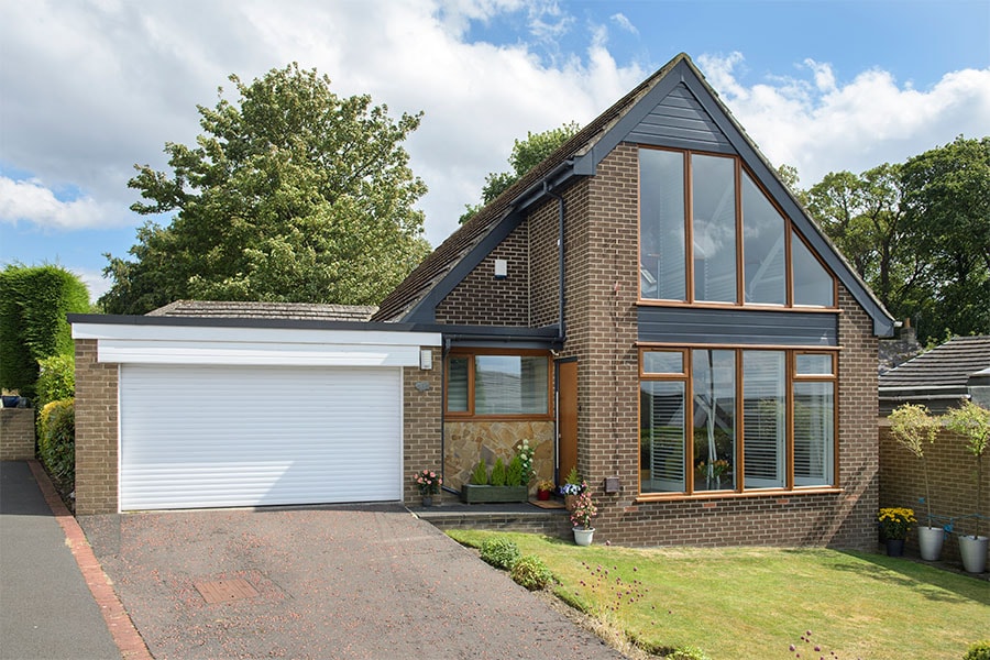 Black uPVC bargeboard with golden oak windows whole house