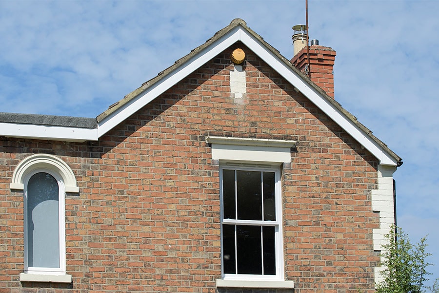 White uPVC bargeboards and white sliding sash windows