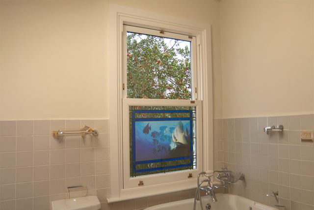 colourd window on sash bathroom interior