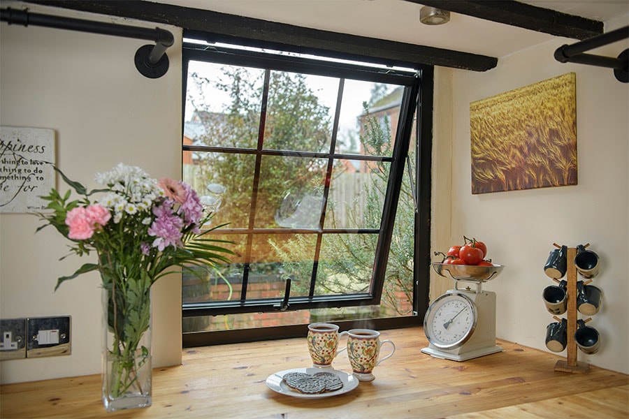Jet black aluminium casement window with Georgian insert bars