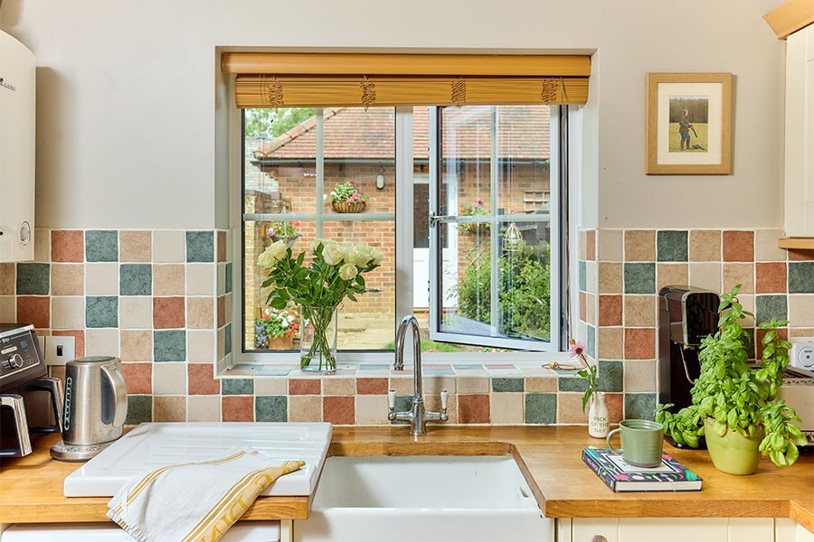 White Aluminium casement window with Georgian insert bars in kitcejn open position