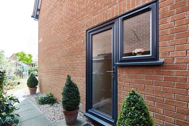 Anthracite grey uPVC window next to door