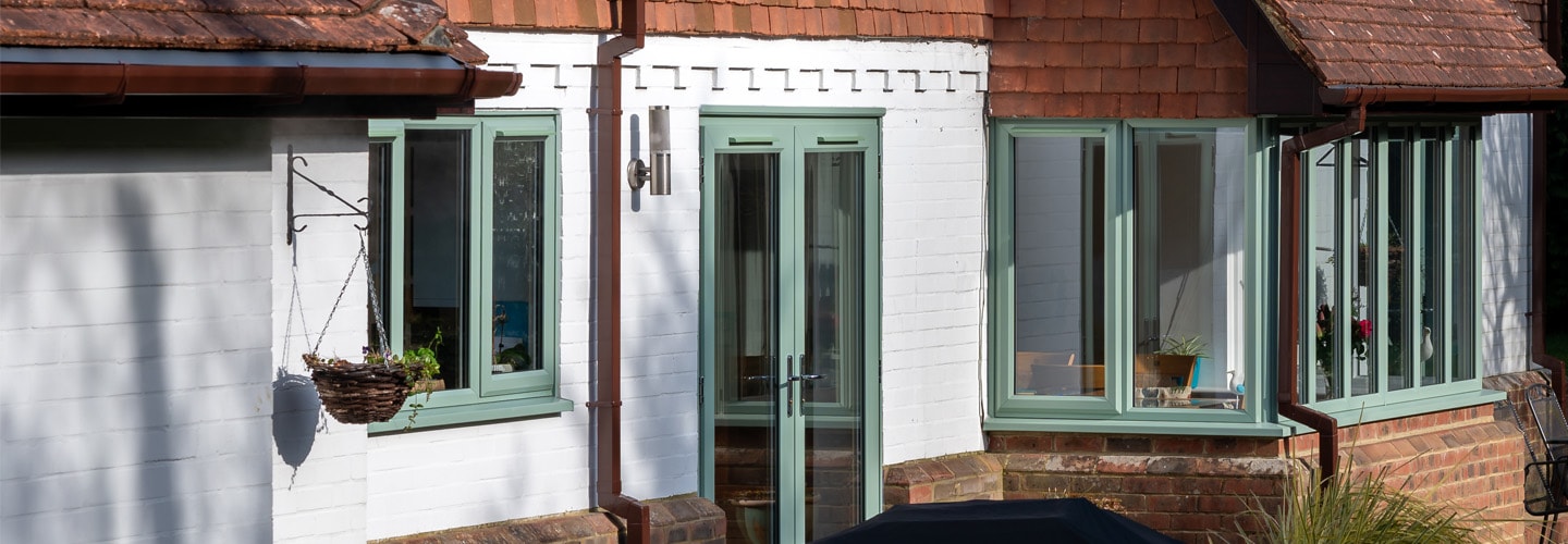 Sage green back door and uPVC casement windows banner