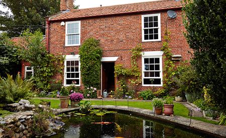 Country house white wooden sash window replacement with Cottage bars from the Anglian sash windows range