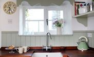 Narrow White cottage UPVC casement kitchen window with black window handle from the Anglian cottage window range